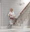 senior woman riding a stairlift