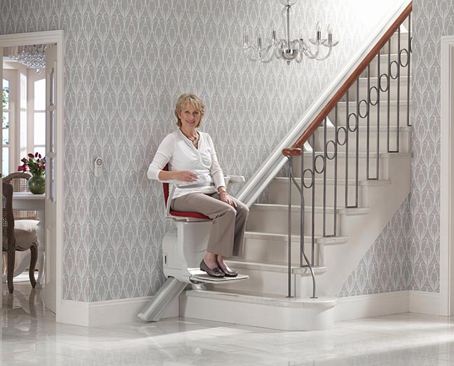 senior woman riding a stairlift