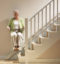 stannah siena old lady climbing up stairs with a stairlift