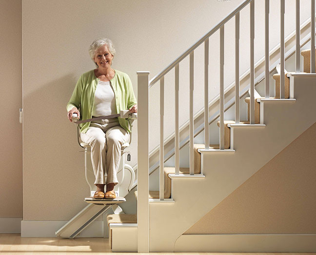 stannah siena old lady climbing up stairs with a stairlift