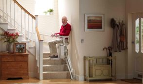 man on a stairlift chair
