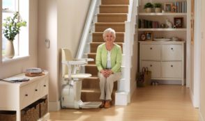 old lady in a staircase with a stairlift