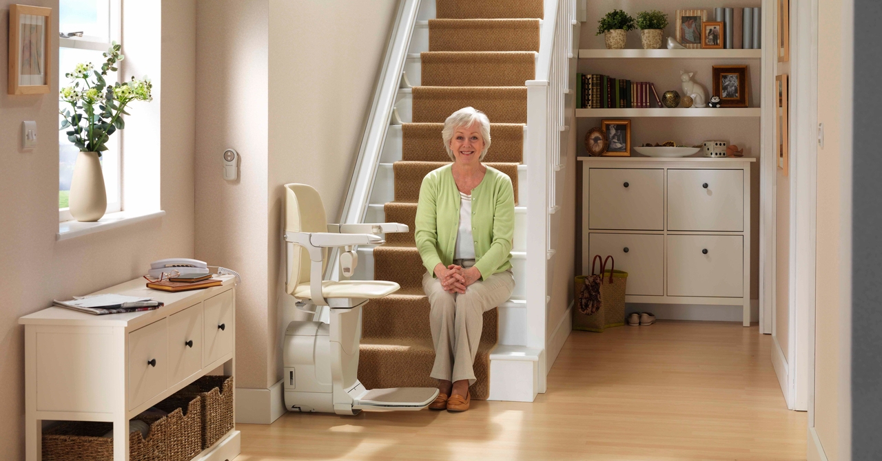 old lady in a staircase with a stairlift